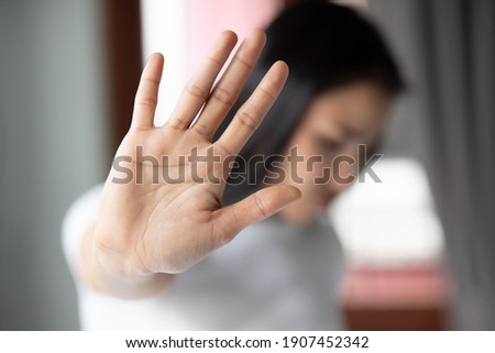 rejecting woman saying stop, no, halt with hand gesture