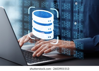Relational database RDB and data model. Database management system DBMS technology. Businessman typing on laptop computer keyboard at desk in office.