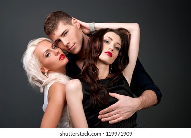 Relations between men and women love passion betrayal. Man and two women, blonde and brunette, love, sexy - the modern concept of love story for three people. Hatred between the two lovers. 