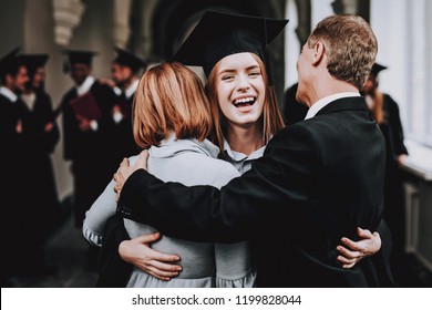 Relations. Diploma. Parents. Congratulations. Student. Finish Studies. University. Graduates. Happy. Good Mood. Have Fun. Architecture. Happiness. Standing. Corridor. Mother. Father. Daughter.