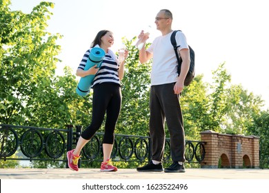 Relationship Between Middle-aged People, Couple Man And Woman 40 Years Old Talking, Relaxing After Fitness In Park, Active Lifestyle