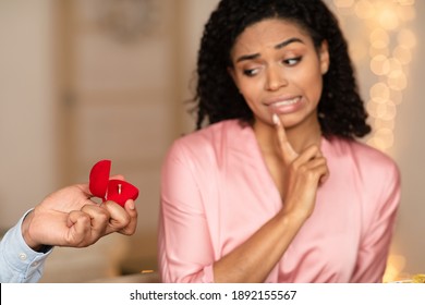 Relationship Breakup Concept. Black man making marriage proposal to young woman rejecting offer, frustrated girlfriend refuse to marry her boyfriend, not taking engagement ring, saying no, thinking