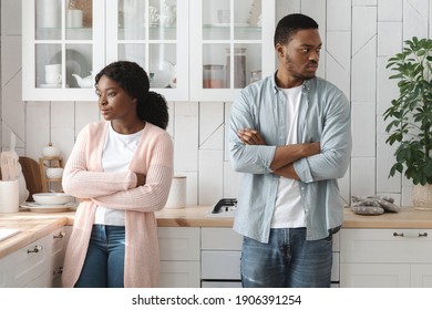 Relationship Crisis. Offended Young Angry African American Spouses Standing In Kitchen After Quarrel, Ignoring Each Other, Black Millennial Couple Suffering Misunderstanding In Relations, Free Space