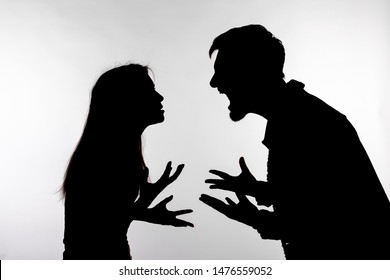 Relationship difficulties, conflict and abuse concept - man and woman face to face screaming shouting each other dispute silhouette isolated on white background