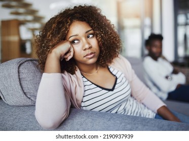 Relationship issues, communication problems and divorce talk of a couple after a fight at home. Upset female feeling frustrated on a living room couch. Annoyed couple on a sitting on a sofa - Shutterstock ID 2190937939