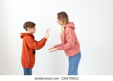 Relationship, Mothers Day, Children And Family Concept - Teen Boy Giving High Five To His Mom On White Background