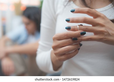 Relationship Problem Concept. Wife Taking Off Marriage Ring After Husband Cheating On Her