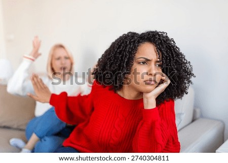 Relationship Problems and Conflict Between Two Diverse Female Friends at Home. Sad Woman Ignoring Her Friend During Argument. Friendship Crisis, Misunderstanding and Mental Health Concept.