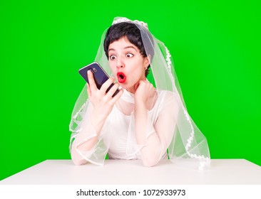 Relationship Problems And Troubles Concept. Annoyed Mad Bride In White Dress Calling To Somebody.
Bride In Shock Looks At The Smartphone Screen