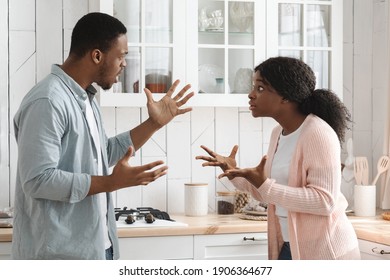 Relationship Problems. Young African American Couple Arguing In Kitchen, Shouting And Blaming Each Other, Black Millennial Spouses Quarreling At Home, Suffering Marital Crisis, Side View, Free Space