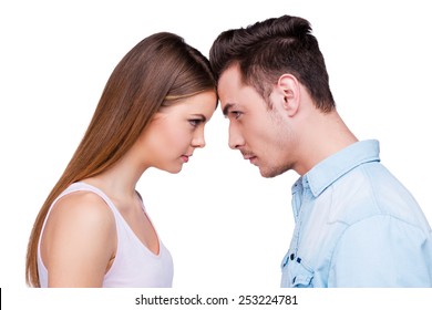 Relationships Without Any Compromise.  Side View Of Young Couple Standing Face To Face And Looking At Each Other While Standing Against White Background 