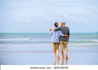 Relax  Asian Senior Couple  On Beach  With  Blue  Sky  Background , Retirment  Travel  Holiday Healthy Lifestyle Concept 