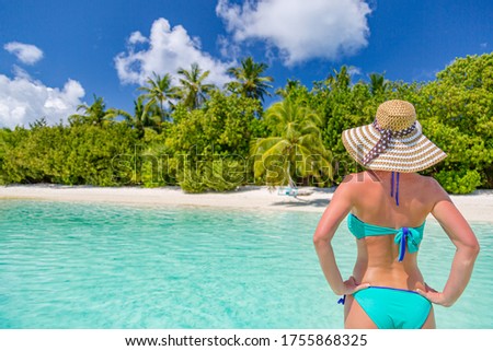 Relax beach woman bikini portrait in tropical island paradise. Beach resort girl with palm trees and luxury summer vibes. Happy woman at beach landscape, summer vacation holiday. Travel exotic nature