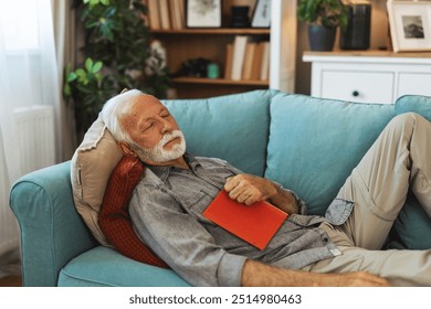 Relax, book and senior man sleeping in the living room of his modern house on a weekend. Calm, peace and elderly male person in retirement taking a nap after reading a story or novel at home. - Powered by Shutterstock