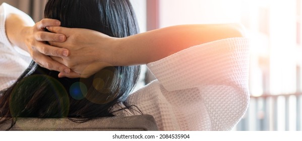 Relax Business Woman Lifestyle At Home Sitting On Modern Chair In Living Room Looking Out Of Window Toward Beautiful Cityscape Downtown Urban Landscape City Life With Sunlight Effect