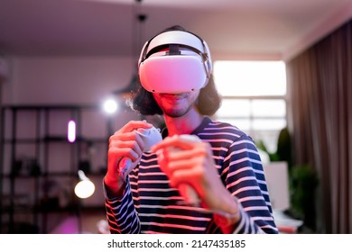 relax casual Asian adult Man Wearing Virtual Reality Headset and Holding Controllers Plays in a boxing sport Video Game at Home. Playing VR active sport game online in the Living Room with rgb lightin - Powered by Shutterstock