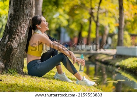 relax casual asian female sportwoman break time after finish morning run exercise healthy lifestyle ,asian female relax cooling down after run training under the tree near water in the park