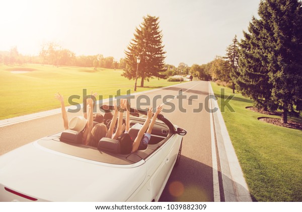 Relax chill destination, auto vehicle rent, speed\
ride, students lifestyle. Festive joyful ladies and guy driver,\
chics girlfriends express vitality, emotions, success, euphoria,\
fly, hair, wind, sun