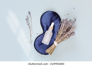 Relax composition with sleep mask, lavender oil and lavender flowers on blue background. Lavender oil is the best natural remedy for treatment of depression, insomnia and nervous stress - Shutterstock ID 2139901803