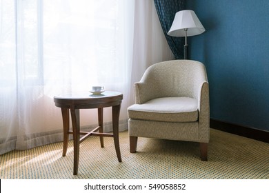 Relax Concept : Vintage Chair, Cup Of Tea On Wooden Table With Lamp On Deserted Old Carpet Floor. 