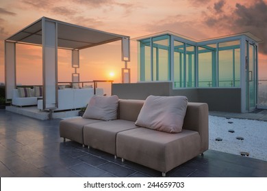 Relax Coner On Condominium Roof Top Garden With Sofa And Table