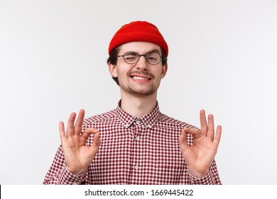 Relax I got this. Pleased confident young man assure all okay, smiling showing ok gesture and nod in agreement, impressed with friend awesome project, guarantee everything perfect - Shutterstock ID 1669445422