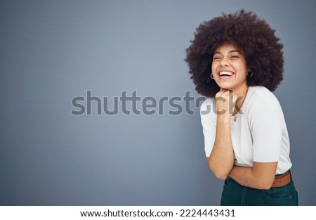 Relax, happy and black woman with natural hair in studio laughing at a funny joke with mockup space. Smile, happiness and young goofy African girl with an afro enjoying comedy, comic and freedom