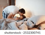 Relax, kiss and father with child in bedroom at night preparing for sleep together at home. Rest, bonding and dad with boy kid laying in bed for nap with connection, love and care at family house.