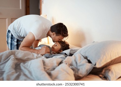 Relax, kiss and father with child in bedroom at night preparing for sleep together at home. Rest, bonding and dad with boy kid laying in bed for nap with connection, love and care at family house. - Powered by Shutterstock