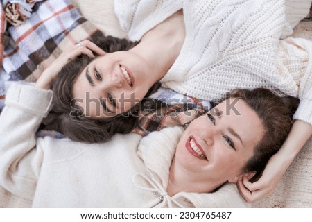 Similar – Image, Stock Photo Happy couple laughing and covering mouths under duvet