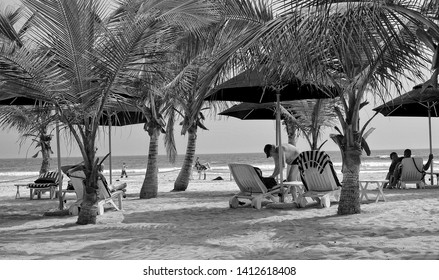 Relax On Beach Under Palm Trees. Black White Photography. Sun Beds And Umbrellas. Sweet Memories About Your Travel & Vacation. Panoramic Skyline. Retro View. Accra, Ghana - 8 January, 2017