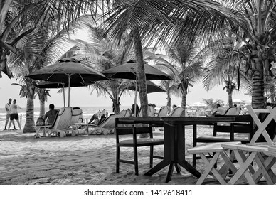 Relax On Beach Under Palm Trees. Black White Photography. Sun Beds And Umbrellas. Sweet Memories About Your Travel & Vacation. Panoramic Skyline. Retro View. Accra, Ghana - 8 January, 2017