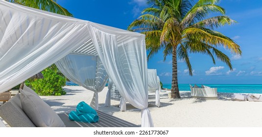 Relax on luxury VIP beach with white pavilions in sunny blue sky. Luxury vacation beach holiday in tropical resort, hotel. Couple retreat Fantastic leisure lifestyle landscape, palm trees white sand - Powered by Shutterstock