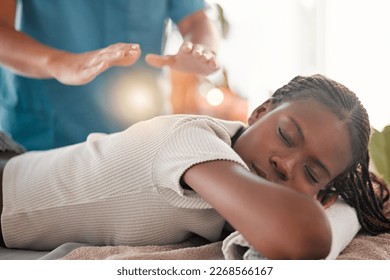 Relax, reiki energy and black woman on bed at spa for chakra therapy and light holistic medicine. Spiritual healing, balance and zen, person with peaceful and healthy mindset at traditional massage. - Powered by Shutterstock