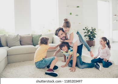 Relax, Rest, Careless, Carefree Concept. Family With Four Children And One Parent Comfort Play Neat Cozy Couch Or Sofa In Modern Light Interior, Ride On Daddy Back And Make Big Smile