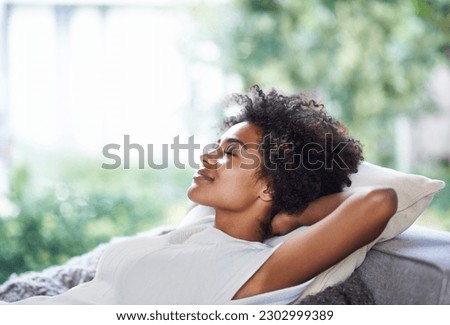 Relax, smile and black woman on sofa sleeping, afternoon nap and rest in calm apartment on weekend. Sleep, daydream ideas and girl on couch relaxing, self care and stress free chill time in lounge.