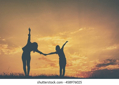 Relax of two women standing and sunset silhouette with copy space.Vintage Tone