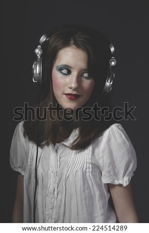 Similar – Young blonde woman listening to music with her headphones