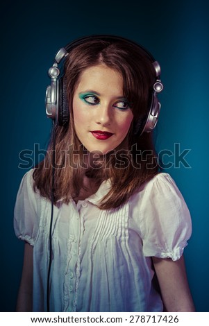 Similar – Young blonde woman listening to music with her headphones