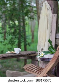 relaxation corner with coffee bread and book, green forest background