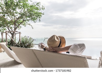 Relaxation holiday vacation of businessman take it easy happily resting on beach chair at swimming pool poolside beachfront resort hotel with sea or ocean view and summer sunny sky outdoor - Powered by Shutterstock