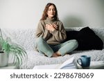 Relaxation techniques: Woman practicing pranayama in lotus position on bed, breathing exercises to reduce stress and anxiety, achieving inner balance and harmony, mindfulness and meditation practice