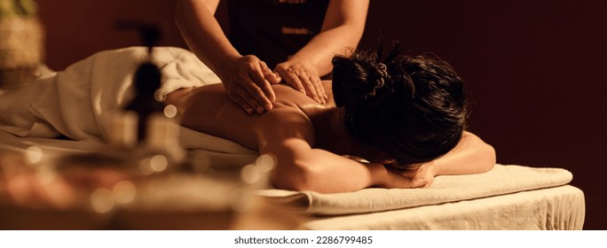 Relaxation woman back massage with masseur in cosmetology spa centre. Relaxing female customer get service aromatherapy massage with masseuse in spa salon.