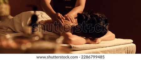 Relaxation woman back massage with masseur in cosmetology spa centre. Relaxing female customer get service aromatherapy massage with masseuse in spa salon.