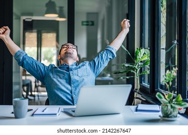 Relaxed adult man, taking a short break from work, by stretching his arms. - Powered by Shutterstock