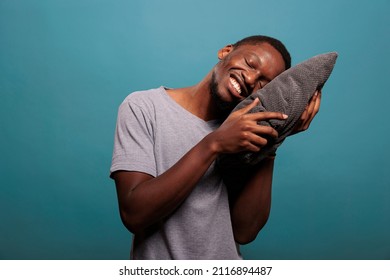 Relaxed Adult Putting Head On Comfortable Pillow To Sleep And Take Nap In Studio. Exhausted Guy Trying To Get Rest After Passing Bedtime And Dealing With Insomnia, Sleeping Schedule.