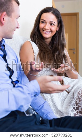 Relaxed american husband and wife joking about something at home