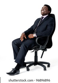 Relaxed Black Businessman Sitting In Office Chair Isolated On White