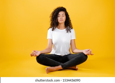 Relaxed Black Woman Meditating In Yoga Pose Isolated Over Yellow