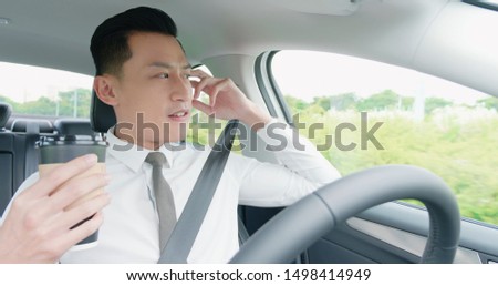 relaxed business asian man experience to riding an autonomous self driving car and drink a coffee